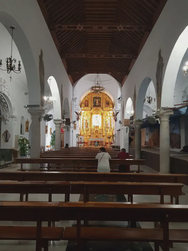 Het interieur van de Iglesia de la Inmaculada Concepción in Mijas met gouden altaar en houten plafond